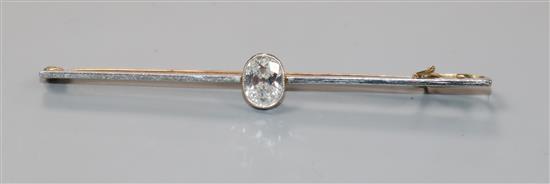 A yellow metal and solitaire oval cut diamond set bar brooch, 64mm.